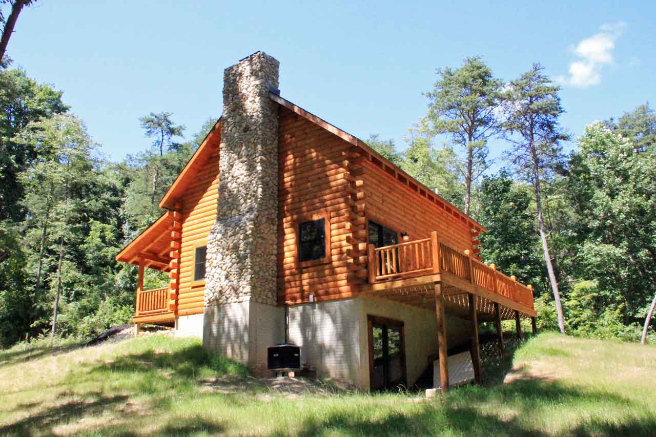 Wooden log cabin surrounded by trees
